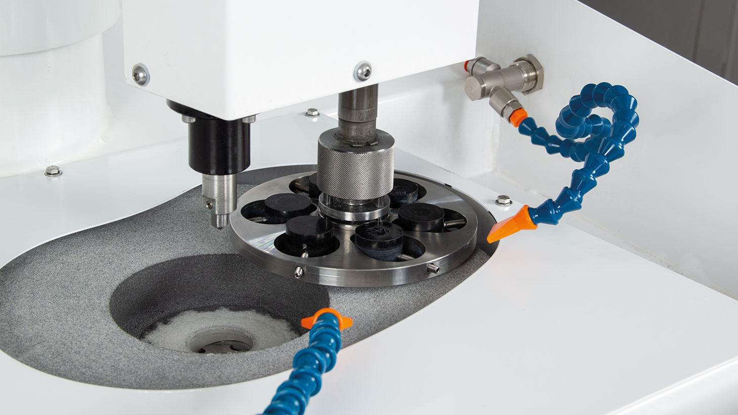 Prepolishing of coated samples, mounted on a central pressure sample holder.