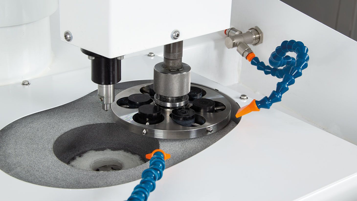 Prepolishing of coated samples, mounted on a central pressure sample holder.